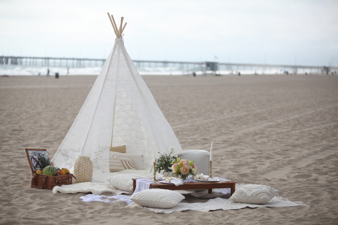 Classic white boho luxury picnic at the beach