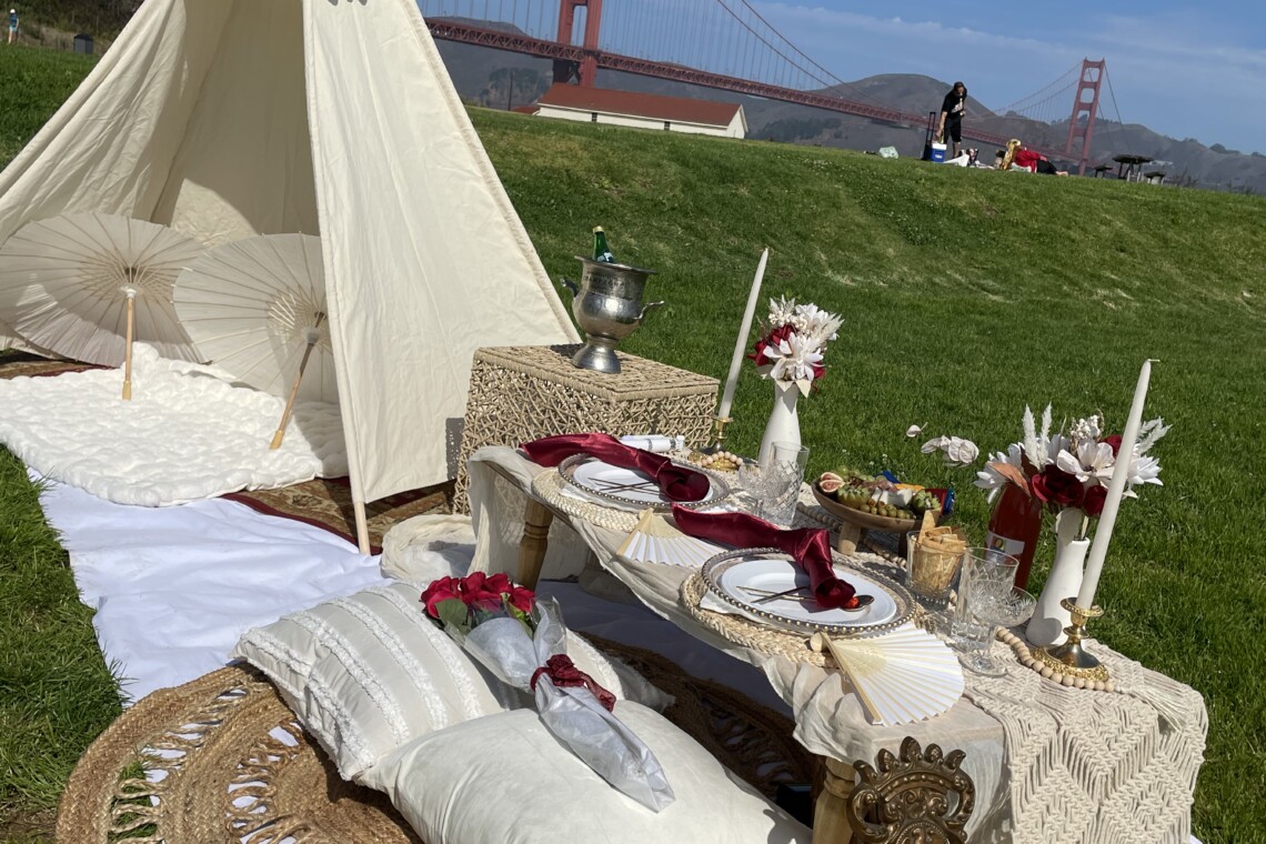 Romantic luxury picnic at Crissy Field, with SF's Golden Gate Bridge in the background.