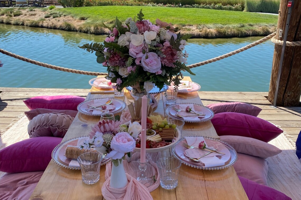 A pink picnic San Francisco Set up overlooking the water at Golden Gate Park.