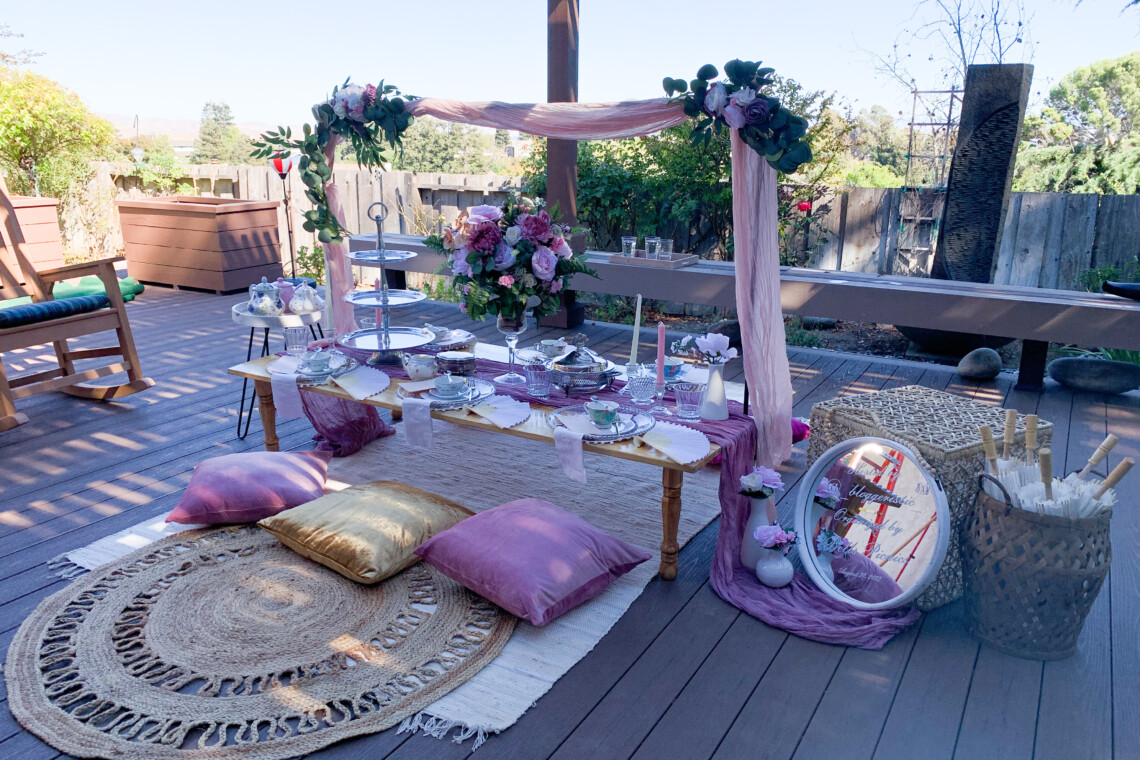 Gold and Purple themed luxury picnic with large floral bouquet as centerpiece